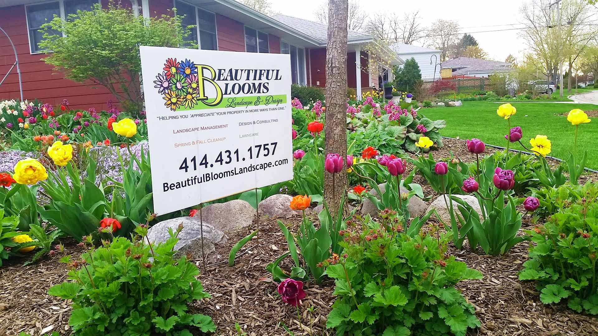 Homeowner, who is proudly displaying that he receives services from Beautiful Blooms, LLC.
