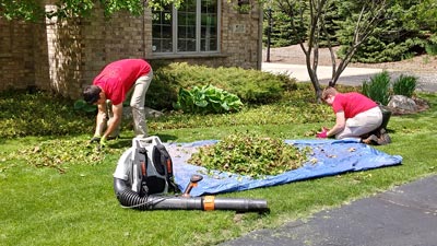 Landscape workers clearing a yard of leaves and trimmings in Pewaukee, WI.